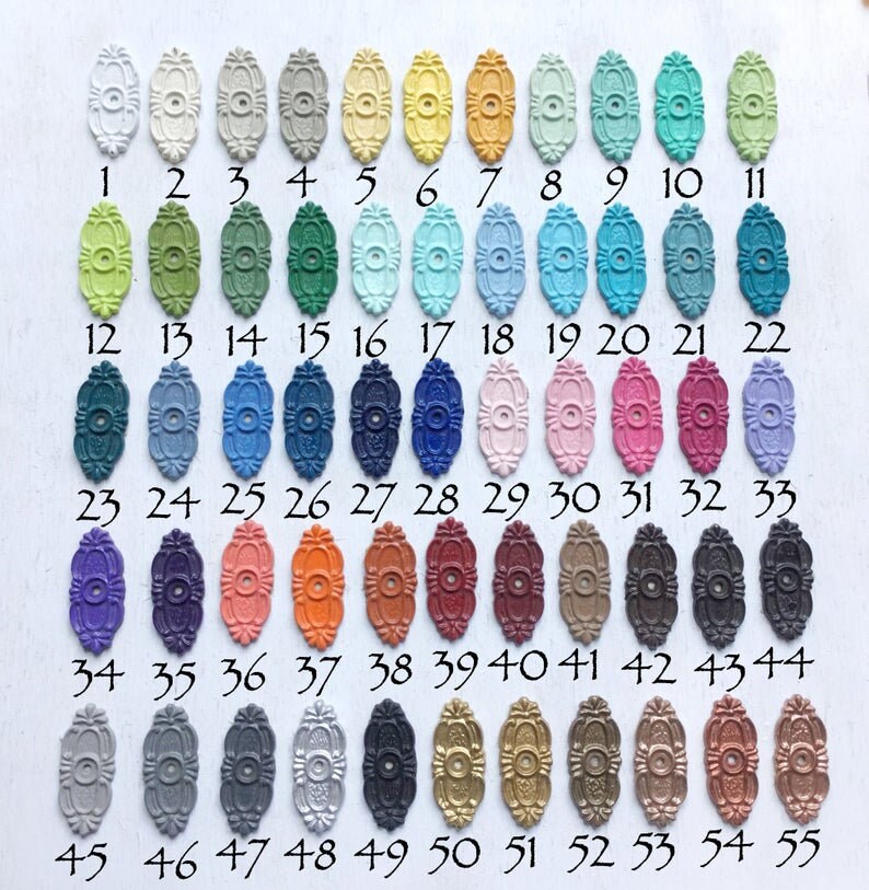 May include: A chart of 55 small oval-shaped metal pieces, each painted a different color. The pieces are numbered 1 through 55.