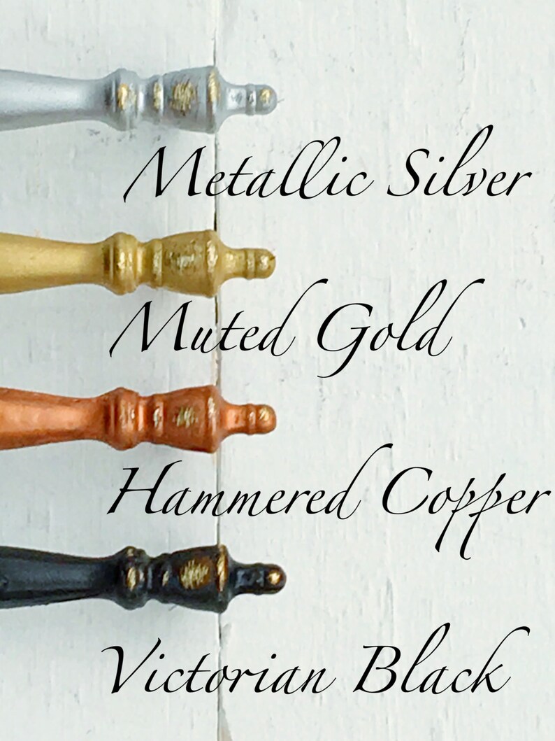 May include: Four decorative cabinet knobs in different finishes: metallic silver, muted gold, hammered copper, and Victorian black.