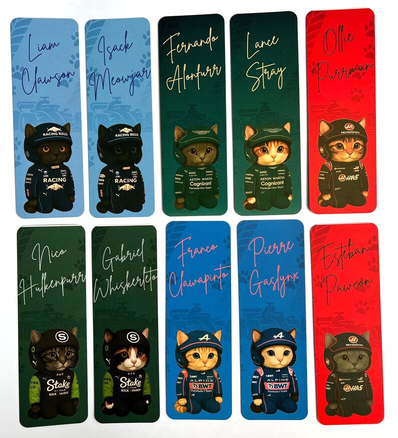 May include: A collection of ten rectangular bookmarks featuring cartoon cat illustrations dressed in racing attire. Each bookmark has a different name written in cursive, with paw prints at the top. The color scheme varies, including blue, green, and red backgrounds.