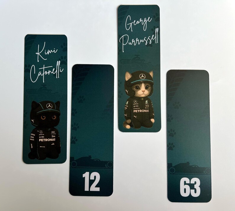 May include: Four bookmarks with a teal background. Two bookmarks feature a black cat and a gray and white cat wearing a racing uniform and cap. The other two bookmarks have the numbers 12 and 63. The names "Kimi Catonelli" and "George Purrussell" are written on the bookmarks.