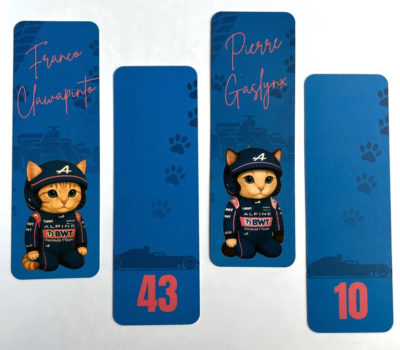 May include: Four blue bookmarks featuring a cartoon cat in a racing suit and helmet. The bookmarks have names and numbers: "Franco Clawapinto", "43", "Pierre Gaslynk", and "10". Paw prints and race car silhouettes decorate the background.