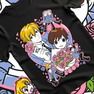 May include: Black t-shirt with a vibrant anime-style illustration. The design showcases multiple characters, pink roses, and a pink and white heart-shaped border. The characters are dressed in blue suits and holding roses.