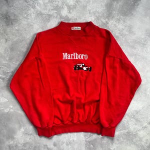 marlboro cigarette sweatshirt cigarettes merch Marlboro Cigarettes Cowboy Retro Graphic T-Shirt The Cignetti Marlboro Cigarette Sweatshirt is the ultimate parody design Streetwear Is Making Cigarette Logos
