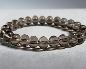Armband av naturligt rökkvarts med klara bruna kulramspärlor