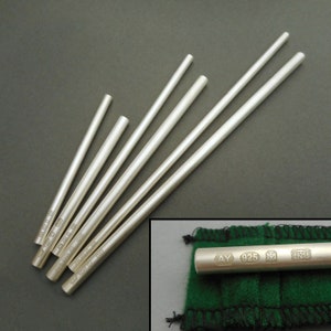 May include: Six silver rods of varying lengths, each with a different inscription. The inscription on the shortest rod reads "925 AY 1925".