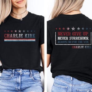 May include: Black t-shirt with the text "CHARLIE KIRK" in red, white, and blue. The back of the shirt features the text "NEVER GIVE UP. NEVER SURRENDER. ALWAYS GO FOR THE WIN. CHARLIE KIRK."