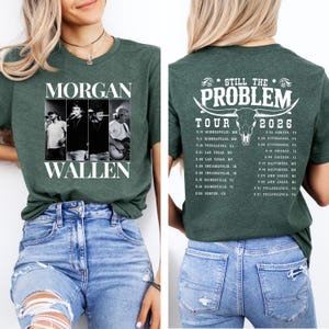 May include: Green t-shirt featuring a black and white image of Morgan Wallen and the text "MORGAN WALLEN". The back of the shirt displays "STILL THE PROBLEM TOUR 2026" with a bull skull graphic and a list of tour dates.