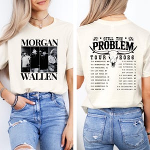 May include: Cream-colored t-shirt featuring a black and white image of Morgan Wallen and the text "MORGAN WALLEN." The back of the shirt displays "STILL THE PROBLEM TOUR 2026" with a bull skull graphic and a list of tour dates.