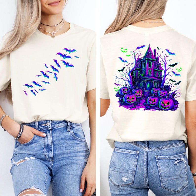 May include: Off-white t-shirt featuring a Halloween design. The front displays a flock of bats in shades of blue and purple. The back showcases a haunted house, pumpkins, and bats in vibrant colors, perfect for the spooky season.