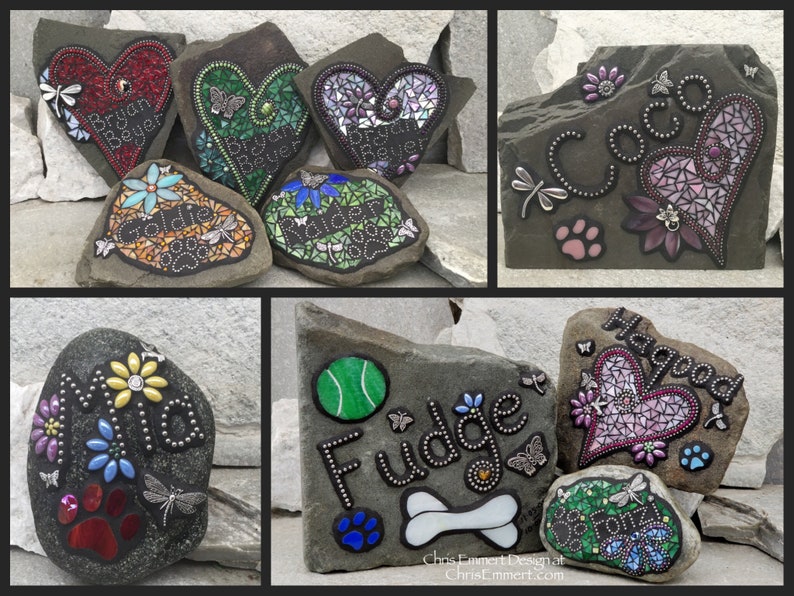 May include: A collection of decorative stone pet memorials. Each stone features a mosaic design, names, paw prints, and dragonfly or butterfly accents. The stones are in various shapes and colors, suitable for garden or home decor.