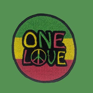 May include: Embroidered patch with a green, yellow, and red color scheme, featuring the words "ONE LOVE" in black, yellow, and pink. A peace symbol is in the center of the word "LOVE". The patch is circular with a black border, set against a green background.