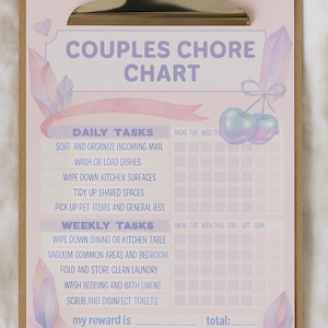 May include: A pink couples chore chart with a silver clip. The chart includes daily and weekly tasks, such as washing dishes and vacuuming. The text "COUPLES CHORE CHART" is at the top. Decorative crystals and cherries are also featured.