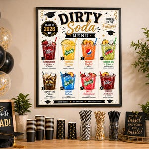 May include: A framed "Dirty Soda Menu" poster with graduation-themed drinks. The poster features colorful soda concoctions, a "Class of 2026" emblem, and the text "Cheers to the Future!" Black and gold balloons and graduation decorations are also present.