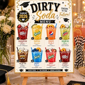 May include: A wooden easel displays a "Dirty Soda Menu" with eight colorful soda variations. The menu features text like "Class of 2026," "Cheers to the Future," and soda names with ingredients. The sign is decorated with graduation caps and stars.