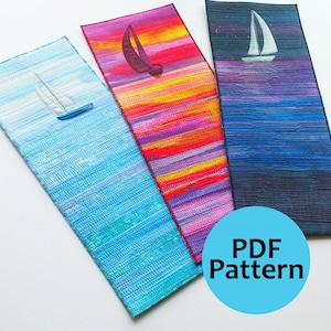 May include: Three fabric bookmarks with a sailboat design. The bookmarks are in shades of blue, purple, and red. The text "PDF Pattern" is on a blue circle.