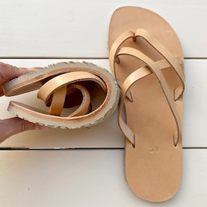 Flexible barefoot sandals bending to show soft Vibram sole and natural movement design