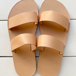 Minimalist leather slide sandals with natural sole