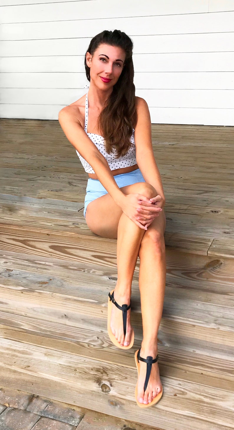 Model wearing black handmade T-strap sandals with a summer outfit, highlighting the elegant and simple minimalist Greek style.