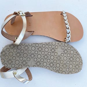 Detailed view of the authentic Vibram rubber sole on our leather barefoot sandals, highlighting the zero-drop flat design and superior grip for natural walking.
