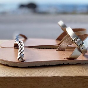 Side view of a gold handcrafted leather barefoot sandal on a neutral background, highlighting the zero-drop architecture and premium artisanal quality.