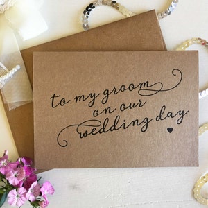 May include: A brown card with the text "to my groom on our wedding day" in black script with a small heart.
