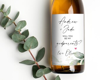 May include: A white wine bottle with a personalized label that says "Andrew + Jade Will you be my godparents? Love Oliver". The label has a watercolor design of green leaves.