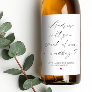 May include: A white wine bottle with a personalised label that says "Andrew will you speak at our wedding?" with the date "17 September 2022" and the names "Love Maddison & Shane".