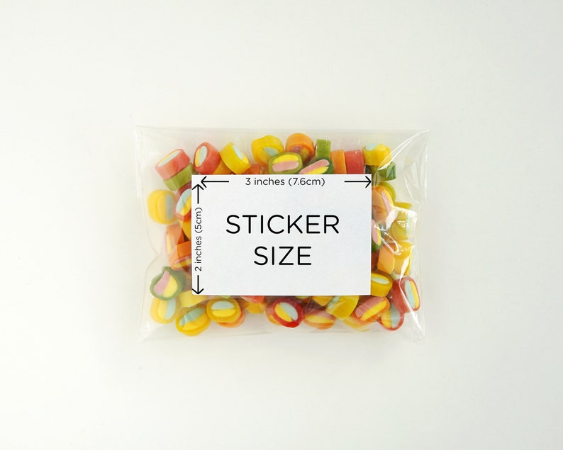 May include: A clear plastic bag filled with colorful candy. The bag is labeled "STICKER SIZE" with measurements of 3 inches (7.6 cm) by 2 inches (5 cm).