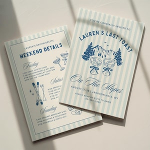 May include: Two rectangular invitation cards with light blue and white vertical stripes. The text reads Lauren's Last Toast, On The Slopes, and Weekend Details, featuring illustrations of mountains, pine trees, martini glasses, and skis.