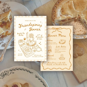 May include: Two cream-coloured Friendsgiving dinner invitations with a hand-drawn illustration of a table setting, a turkey, and a pie. The invitations include the text "Friendsgiving Dinner" and "Dinner Menu". A partially sliced pie is visible.