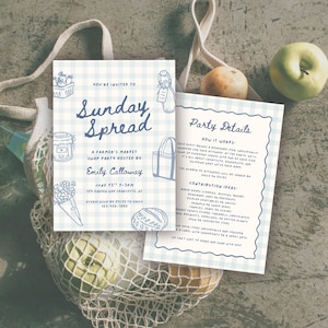 May include: Two light blue gingham-patterned cards with the text "Sunday Spread" and "Party Details" are displayed. The cards are decorated with illustrations of food and a tote bag. A reusable shopping bag holds apples and oranges.
