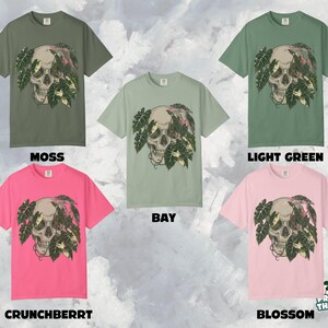 May include: Five short-sleeved t-shirts in various colors: moss, bay, light green, crunchberry, and blossom. Each shirt features a skull graphic with tropical leaves. The text "MOSS", "BAY", "LIGHT GREEN", "CRUNCHBERRY", and "BLOSSOM" are displayed.