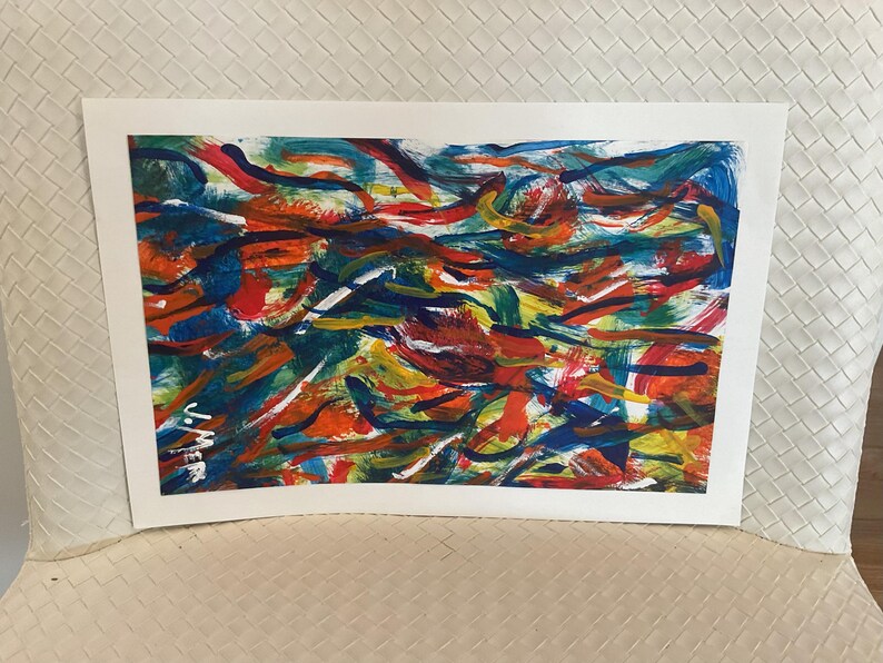 May include: Abstract painting with a vibrant mix of colors. The artwork features bold brushstrokes in shades of red, blue, orange, yellow, and green. The painting is on a white rectangular canvas, creating a dynamic and colorful composition.