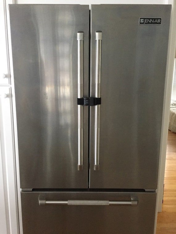 locks on a refrigerator door to keep someone on their diet Stock