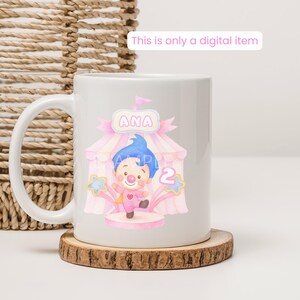 May include: White ceramic mug featuring a colorful circus-themed design with a clown, the name "ANA", and the number "2". The design includes pink and blue accents, stars, and a circus tent. The text "This is only a digital item" is also visible.