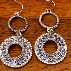 Silver dangle earrings with sparkling blue accents