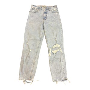 May include: Light wash denim jeans with distressed details. The jeans feature a button and zipper closure, classic five-pocket design, and ripped sections on the legs. The hem is frayed, adding to the casual style.
