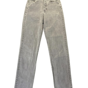 May include: Light gray denim jeans with a high waist and straight leg. The jeans have a button and zipper closure, front and back pockets, and belt loops. The denim has a faded appearance.
