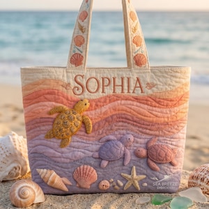 May include: A quilted tote bag with a beach theme. The bag features a colorful ocean wave design with embroidered sea turtles, seashells, and the name "SOPHIA". The handles and top are adorned with seashell embroidery. The text "SEA BREEZE EMBROIDERY" is also visible.