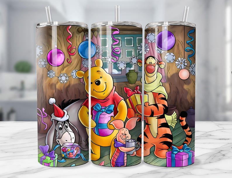 May include: A stainless steel tumbler featuring a festive scene with Winnie the Pooh, Tigger, Eeyore, and Piglet. The design includes Christmas decorations, gifts, and a cozy interior setting. The tumbler has a clear straw and is designed for cold beverages.