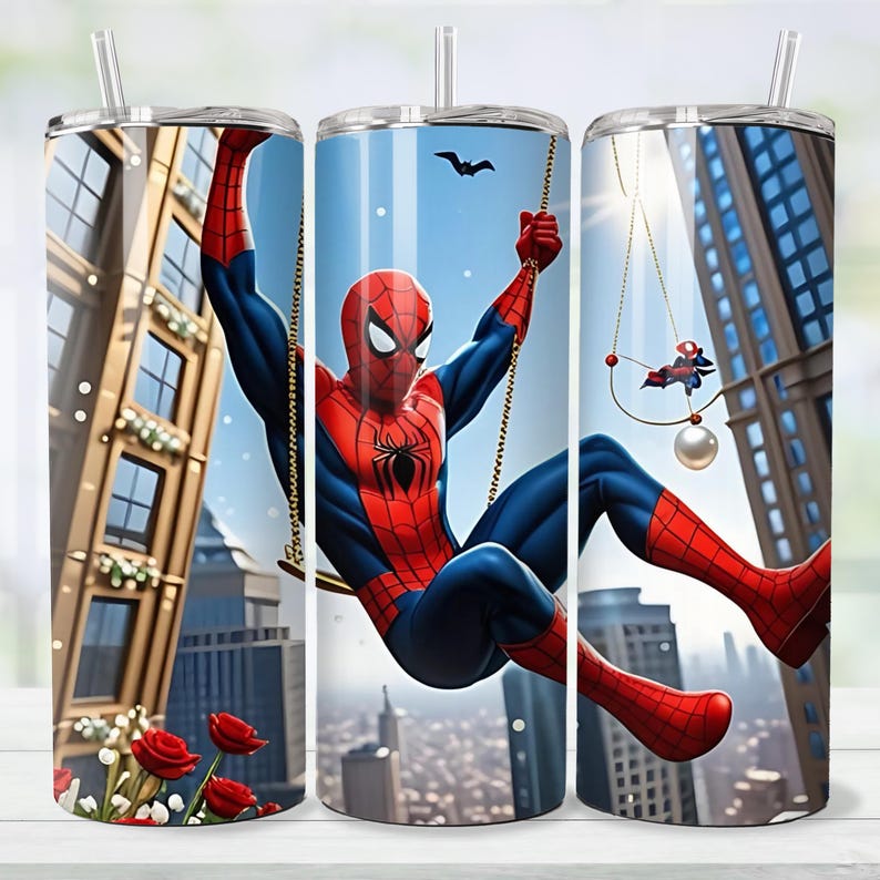 May include: Three stainless steel tumblers with clear straws. Each tumbler has a different scene of Spider-Man swinging through a city. The design includes skyscrapers, a bat, and a small Spider-Man figure.