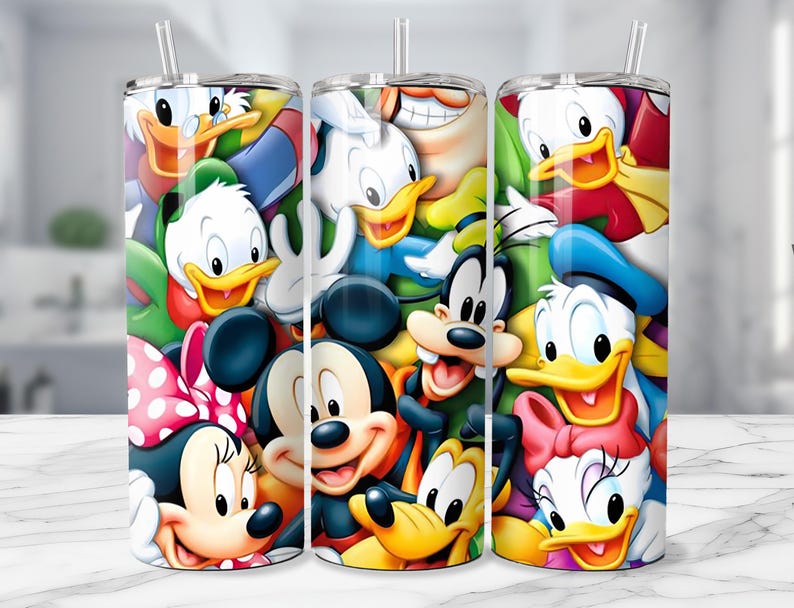May include: Three stainless steel tumblers with colorful cartoon character designs. The designs feature Mickey Mouse, Minnie Mouse, Donald Duck, Daisy Duck, Goofy, and other Disney characters. Each tumbler has a clear straw and a white lid.
