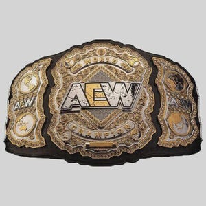 May include: A professional wrestling championship belt featuring a large central gold and silver plate with the text AEW WORLD CHAMPION. The design includes intricate filigree, side plates with globe illustrations, and a black leather strap base.