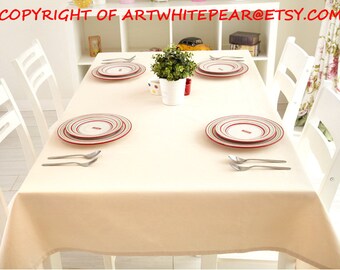 Puede incluir: Un mantel blanco con platos rayados rojo y blanco y tenedores plateados sobre una mesa blanca con sillas blancas.