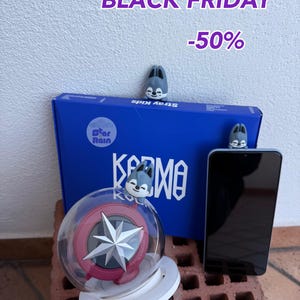 May include: Image features a blue box with "Stray Kids" and "Karma" text, a light stick with a star design, a smartphone, and small gray wolf figurines. The text "BLACK FRIDAY -50%" is displayed at the top.
