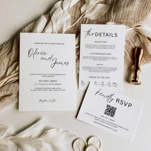 May include: A sophisticated wedding invitation set comprising three white cards with black script. The main card displays the couple's names, date, and venue. Other cards provide reception details and RSVP information, including a QR code.