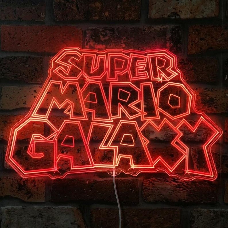 May include: A red neon sign displaying the text "SUPER MARIO GALAXY" in a distinctive font. The sign is set against a brick wall. The neon light emits a bright, warm glow.