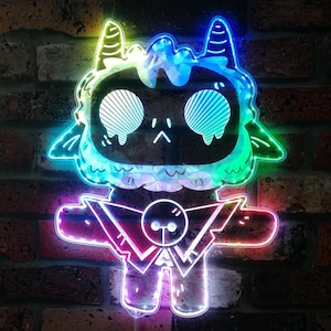 May include: A neon sign depicting a cartoon character with a dark face, large eyes, and horns. The sign is illuminated with a spectrum of colours, including blue, green, and pink. The sign is mounted on a brick wall.