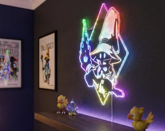 May include: A colorful LED light in the shape of a Final Fantasy character, mounted on a dark wall. The light has a rainbow gradient and is next to a shelf with figurines. The room has framed artwork.