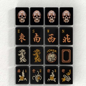 a collection of black square tiles with various symbols and text on them, arranged in a grid-like pattern.